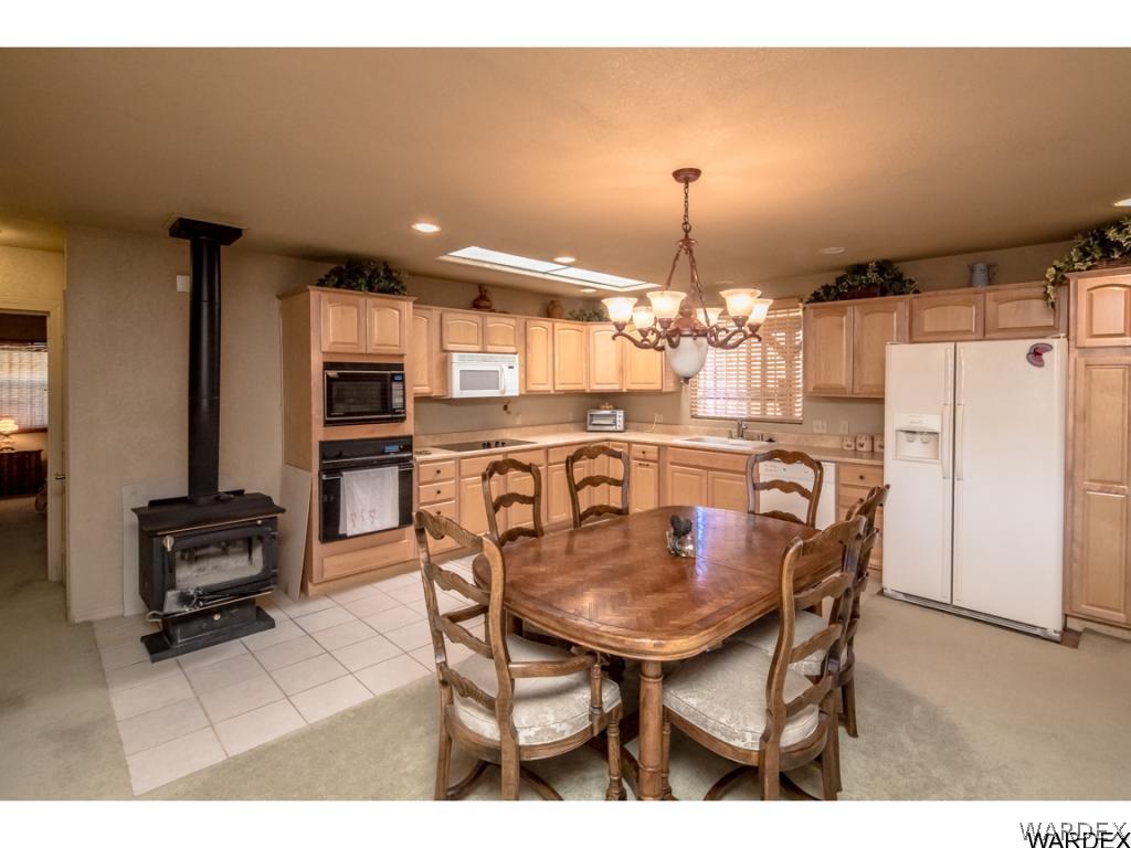 14760 Powerline Road Kingman, AZ 86401 - Photo 22 of 36 a view of a dining room with furniture and chandelier