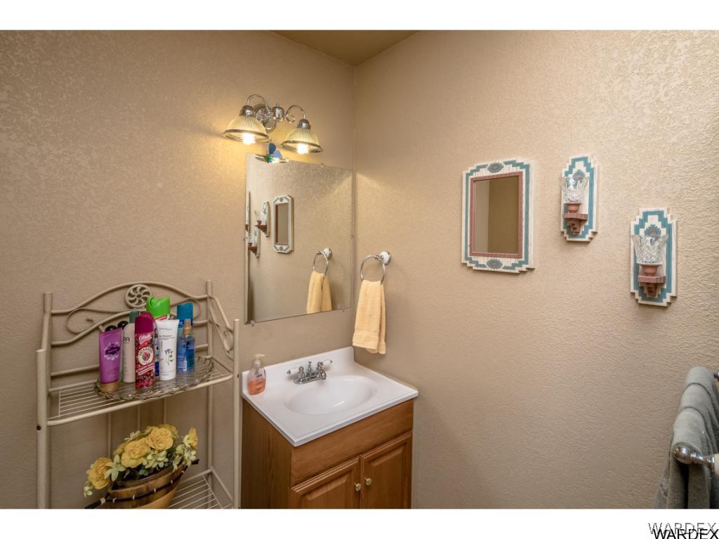 14760 Powerline Road Kingman, AZ 86401 - Photo 28 of 36 a bathroom with a sink vanity and a mirror
