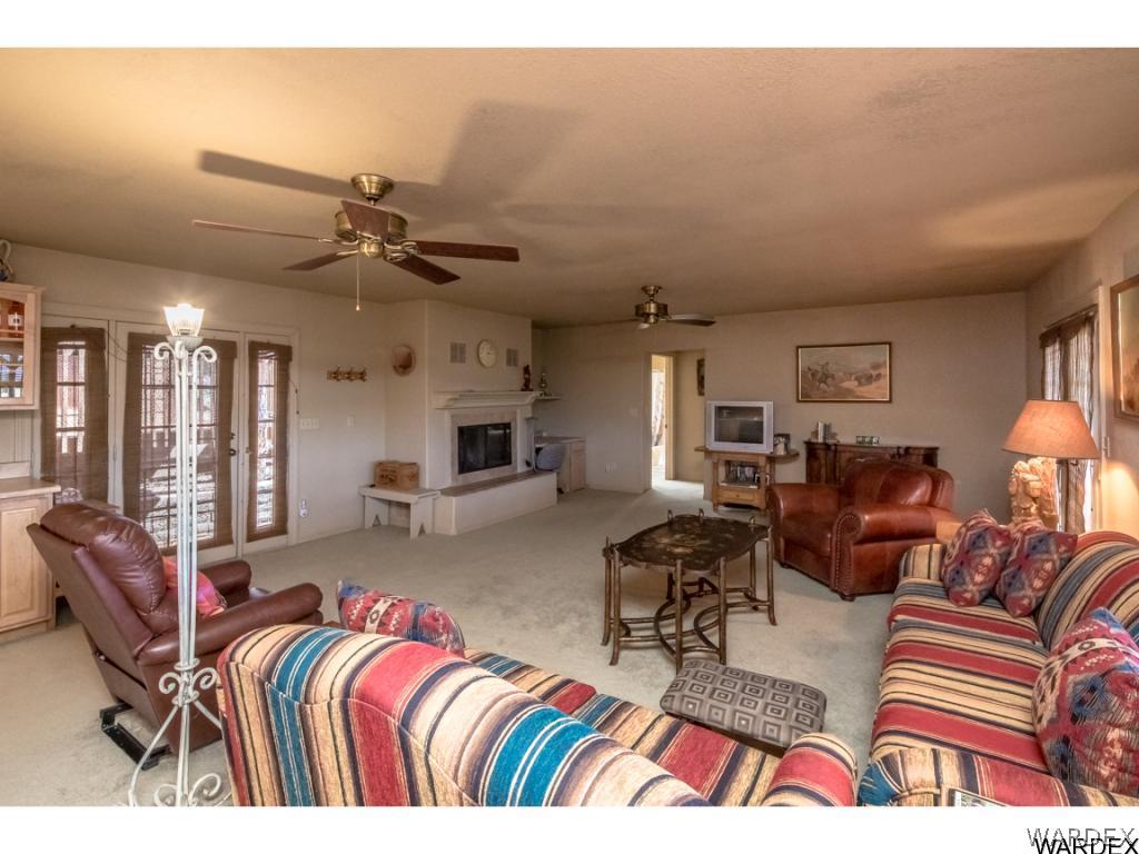 14760 Powerline Road Kingman, AZ 86401 - Photo 3 of 36 a living room with furniture ceiling fan and a rug