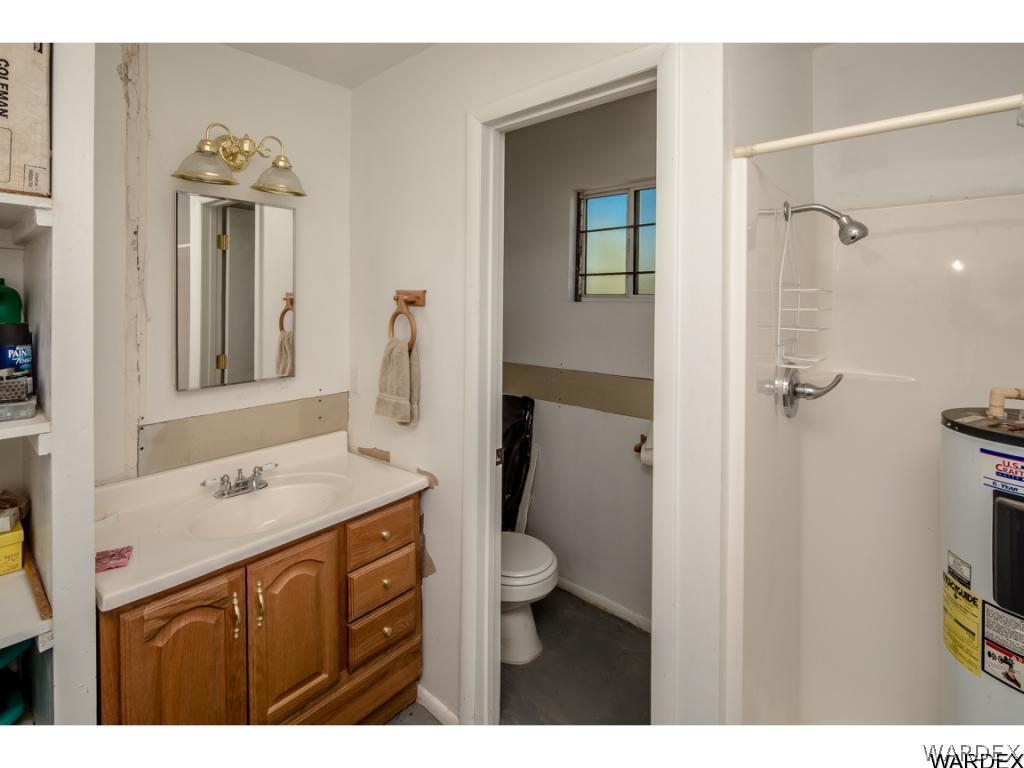 14760 Powerline Road Kingman, AZ 86401 - Photo 32 of 36 a bathroom with a sink vanity granite and a toilet