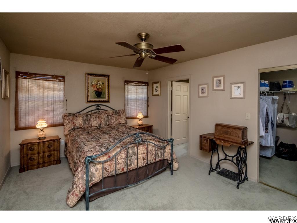 14760 Powerline Road Kingman, AZ 86401 - Photo 5 of 36 a bedroom with a bed a desk and chair