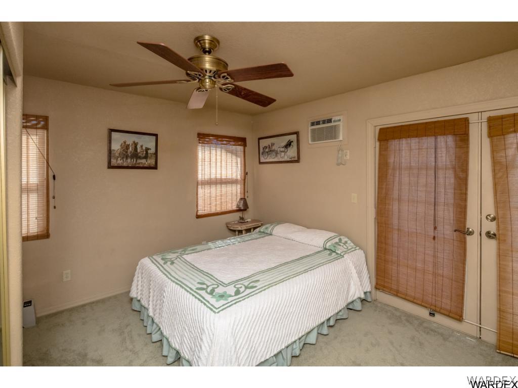 14760 Powerline Road Kingman, AZ 86401 - Photo 9 of 36 a bedroom with a bed and a chandelier