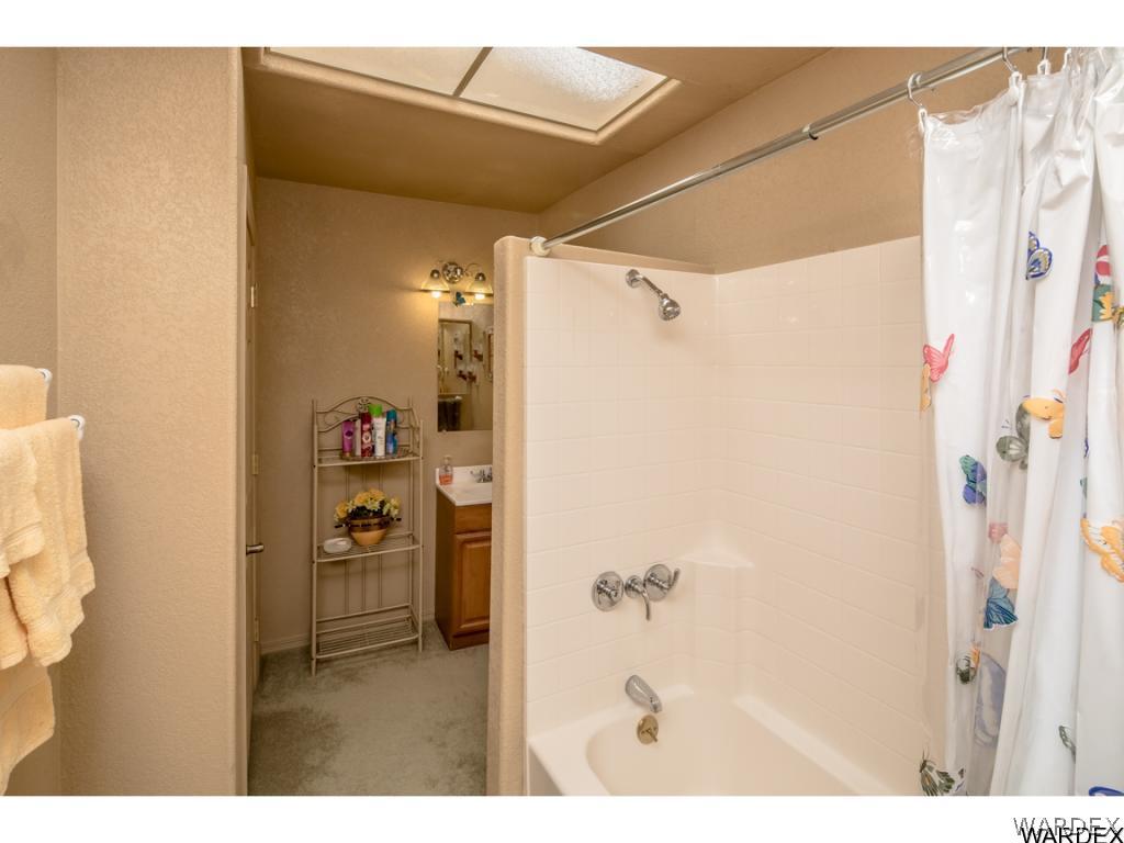 14760 Powerline Road Kingman, AZ 86401 - Photo 10 of 36 a bathroom with a shower and a mirror