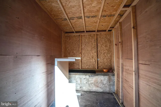 a view of backyard with outdoor seating and barbeque oven