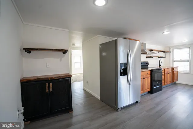a kitchen with stainless steel appliances a refrigerator and a stove top oven