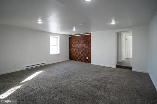 a view of an empty room and a window