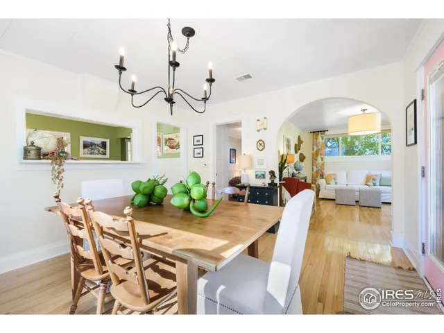 a view of a dining room with furniture and a chandelier