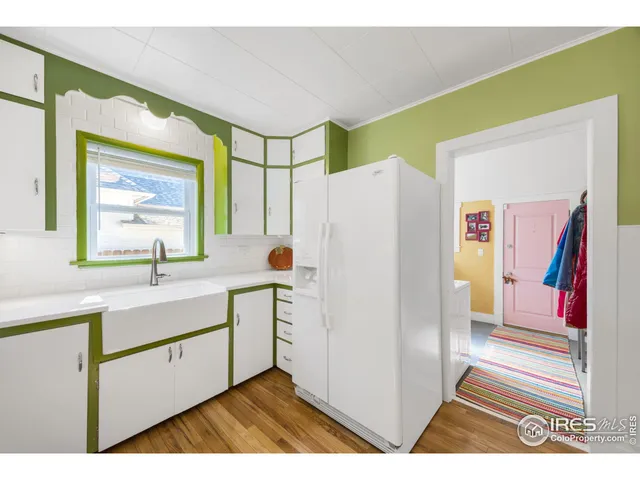 a kitchen with a refrigerator and a sink