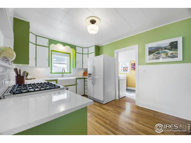 a kitchen with stainless steel appliances a refrigerator and a stove top oven