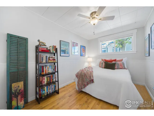 a bedroom with furniture and a book shelf
