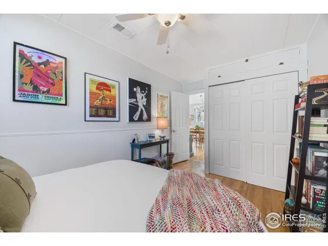 a bedroom with a bed and a bookshelf