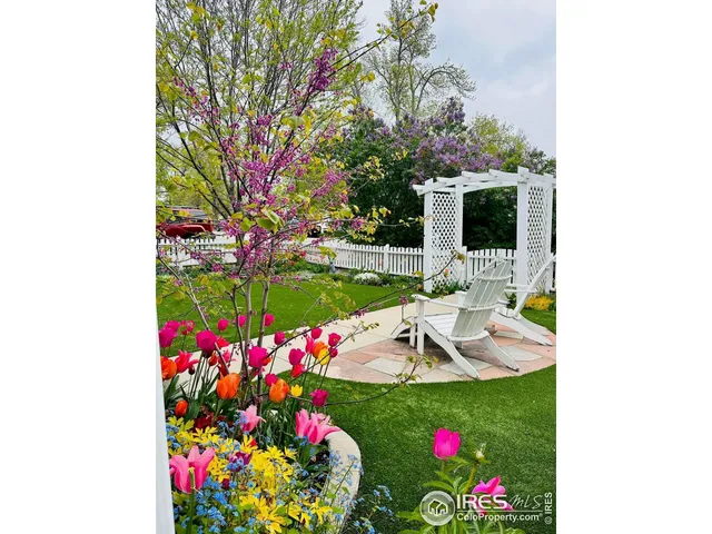 a view of a white bench sitting in a yard with swimming pool