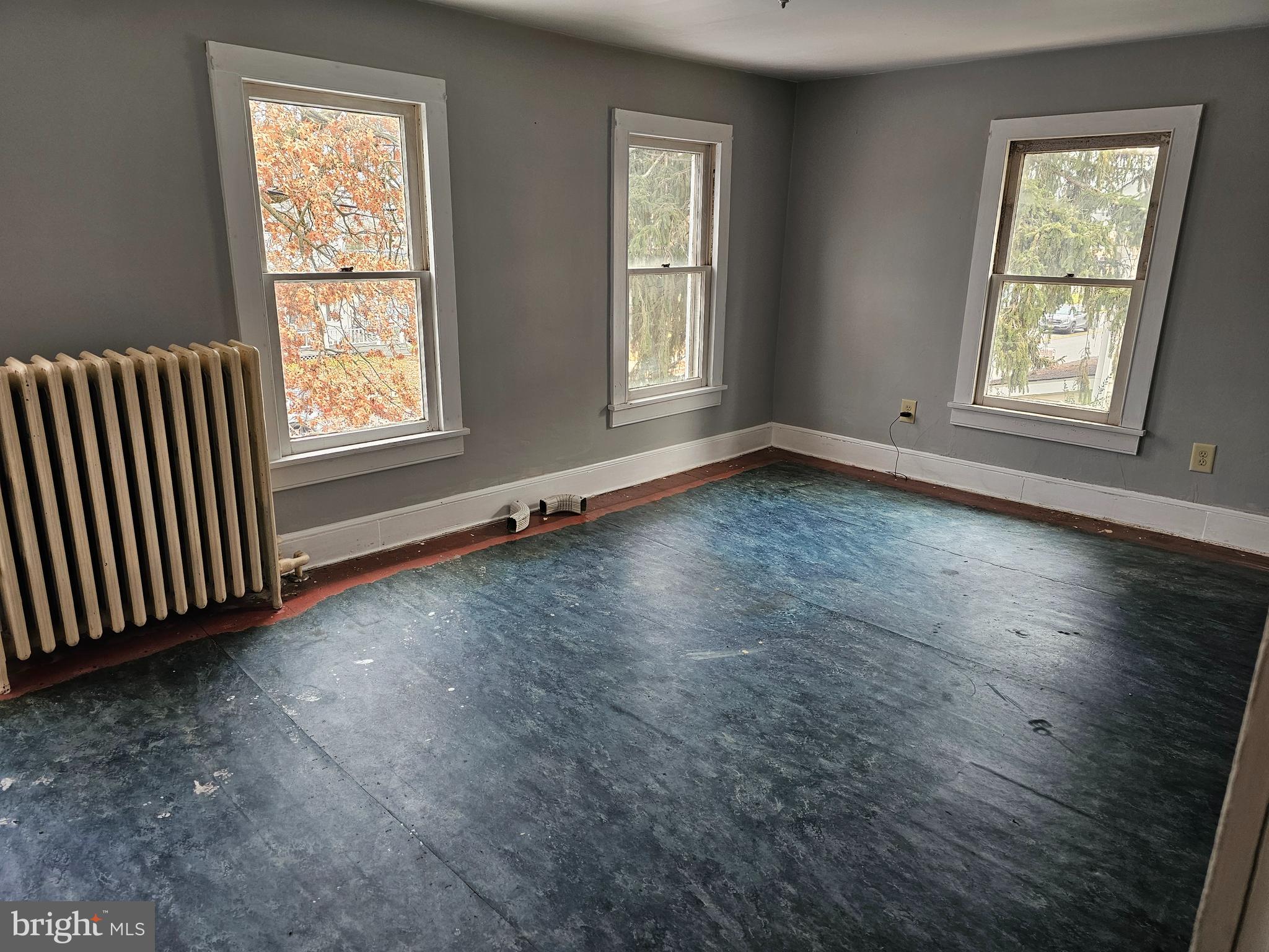 152 North Main Street Elmer, NJ 08318 - Photo 11 of 15 an empty room with wooden floor and windows