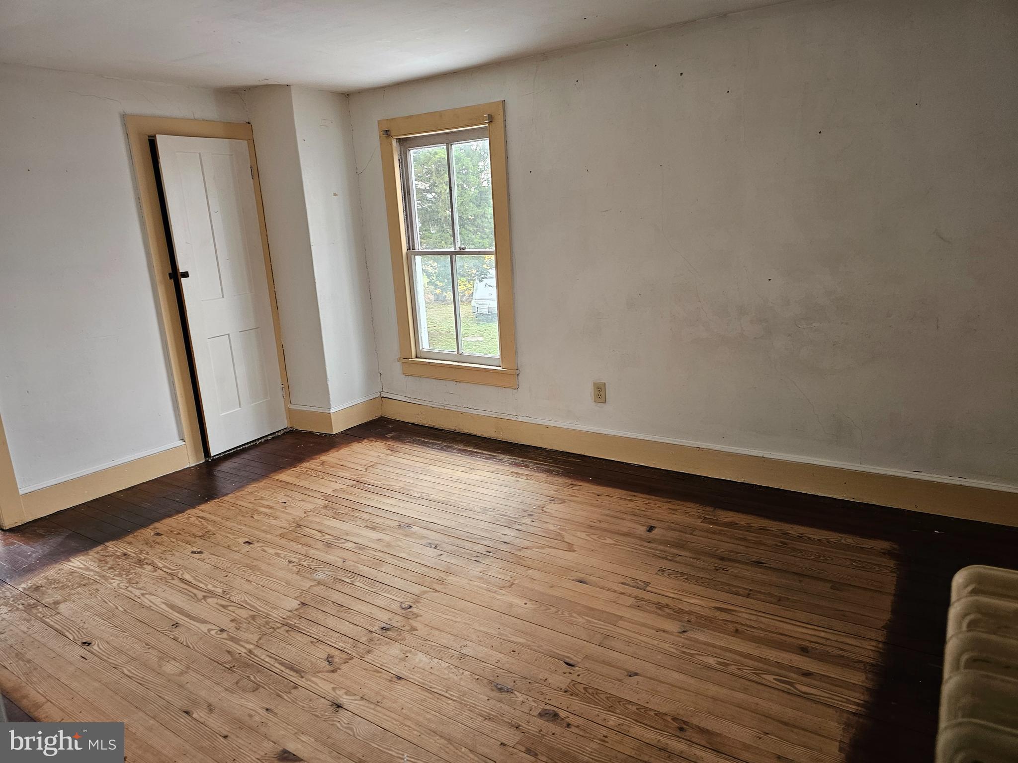 152 North Main Street Elmer, NJ 08318 - Photo 13 of 15 an empty room with wooden floor and window