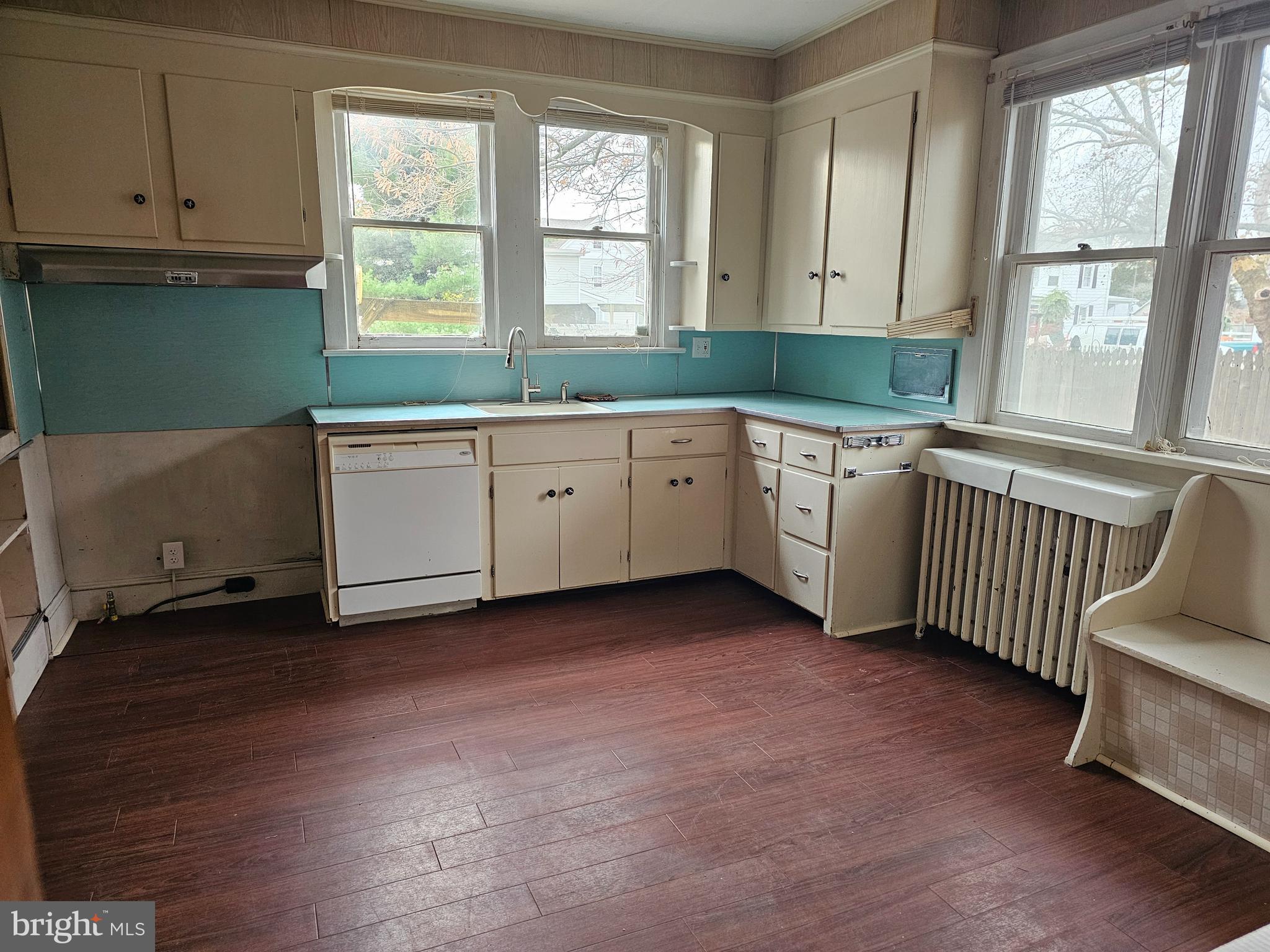 152 North Main Street Elmer, NJ 08318 - Photo 2 of 15 a kitchen with granite countertop a sink cabinets and a large window
