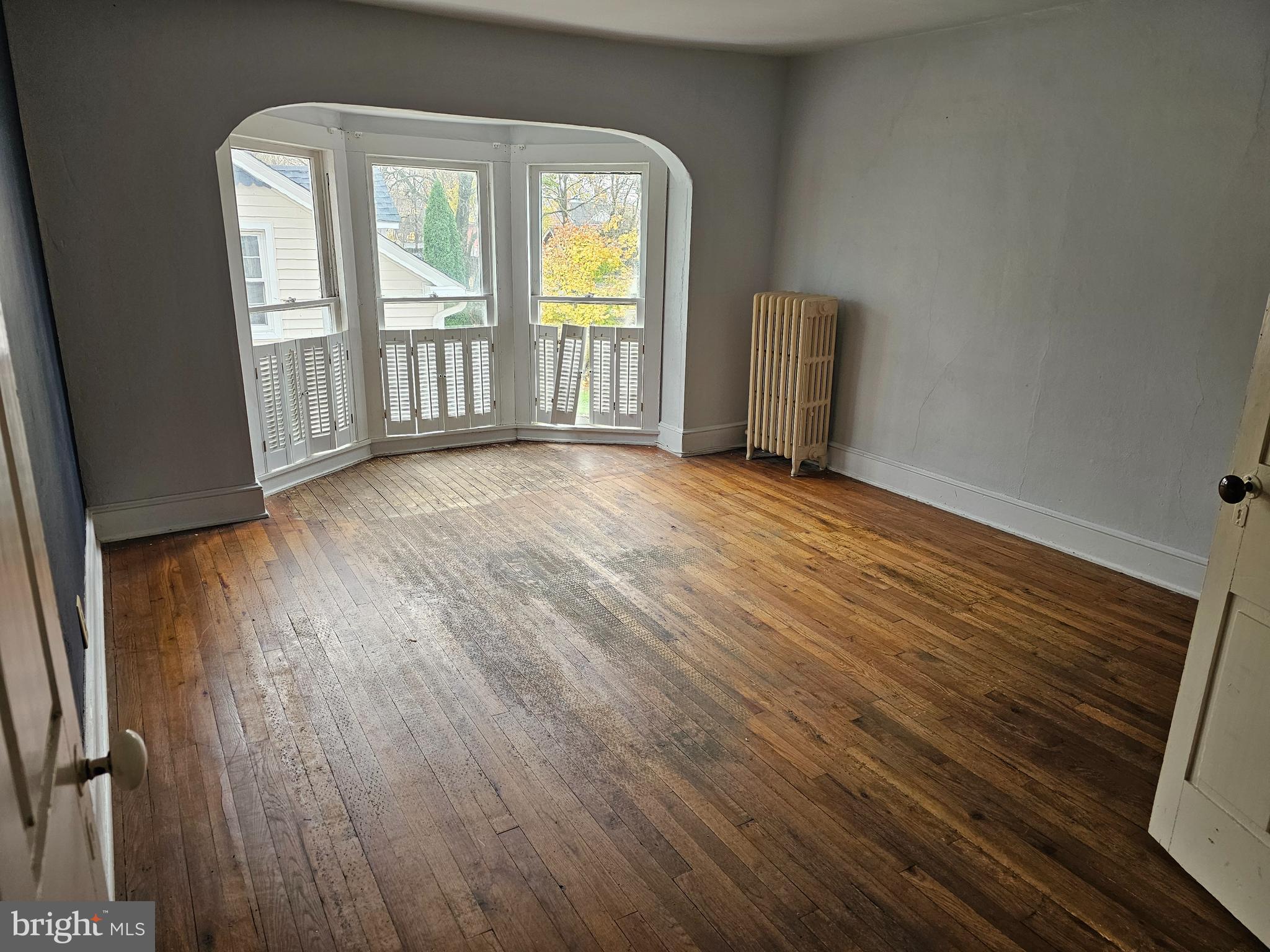 152 North Main Street Elmer, NJ 08318 - Photo 10 of 15 an empty room with wooden floor and windows
