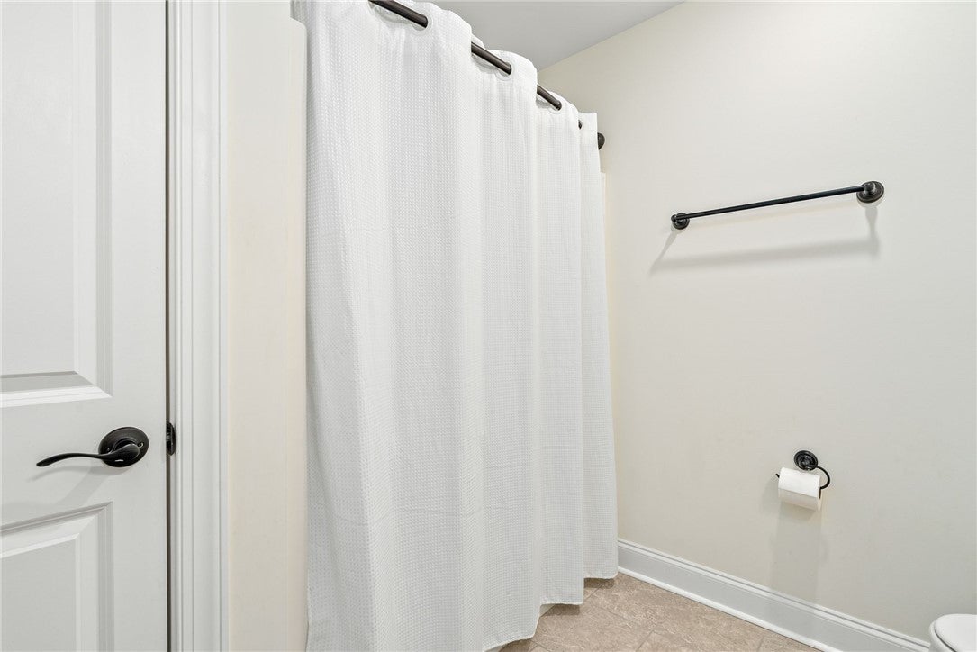 2324 Rutland Road Auburn, AL 36832 - Photo 16 of 22 This clean and inviting bathroom features tiled flooring and essential fixtures for comfortable living.