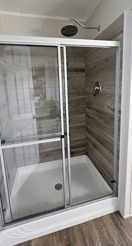 a bathroom with a glass shower door