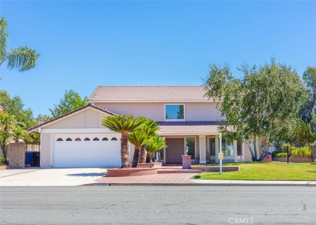42385 Cosmic Drive Temecula, CA 92592 - Photo 1 of 1 a front view of a house with a garden and trees