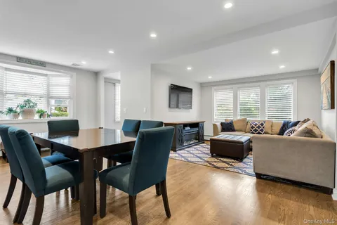 a living room with furniture dining table and a window