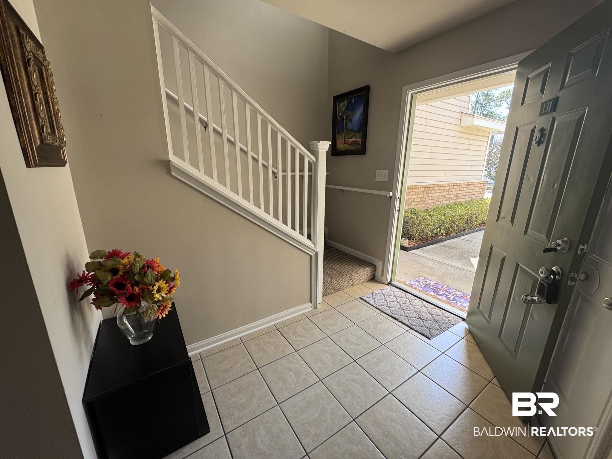 1517 Regency Road, Unit 131 Gulf Shores, AL 36542 - Photo 9 of 21 Foyer featuring stairs and light tile patterned flooring