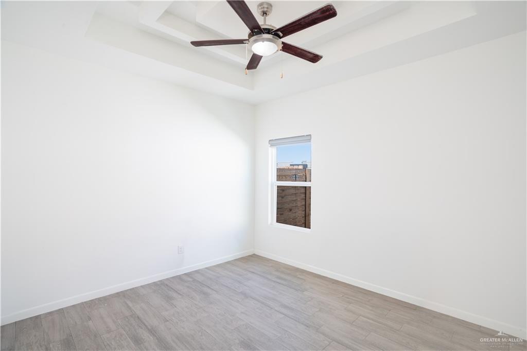 12509 North 40th Street, Unit 4 Edinburg, TX 78541 - Photo 11 of 27 an empty room with a window and ceiling fan