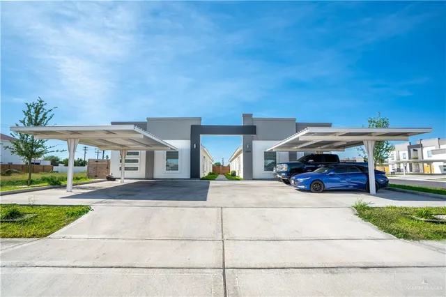 a view of a house with a swimming pool and a yard