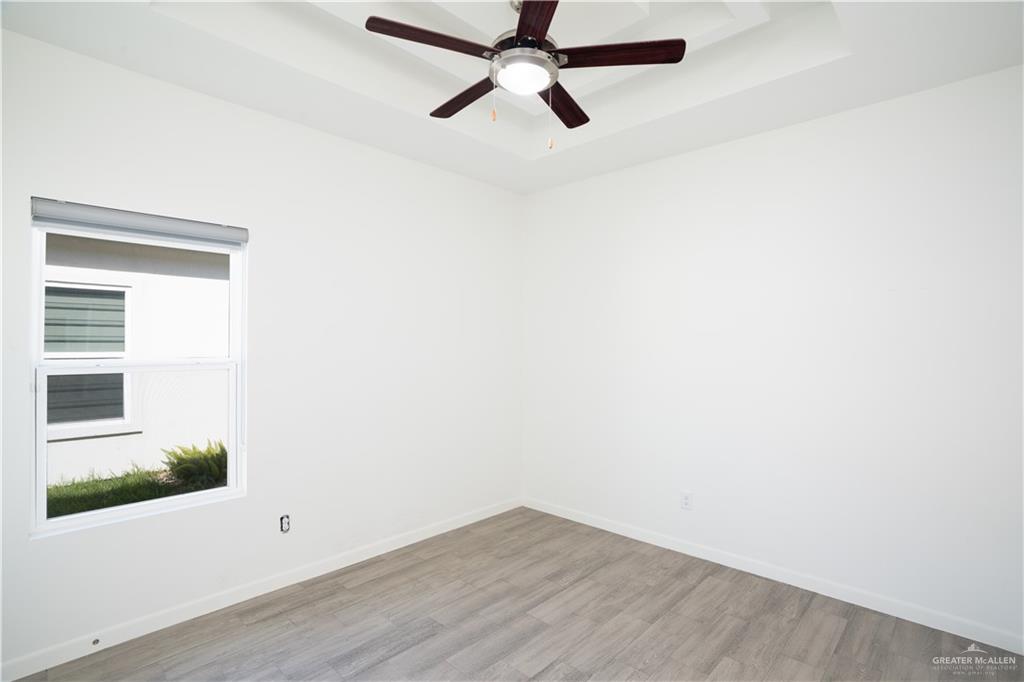 12509 North 40th Street, Unit 4 Edinburg, TX 78541 - Photo 7 of 27 a view of a room with wooden floor and cabinet