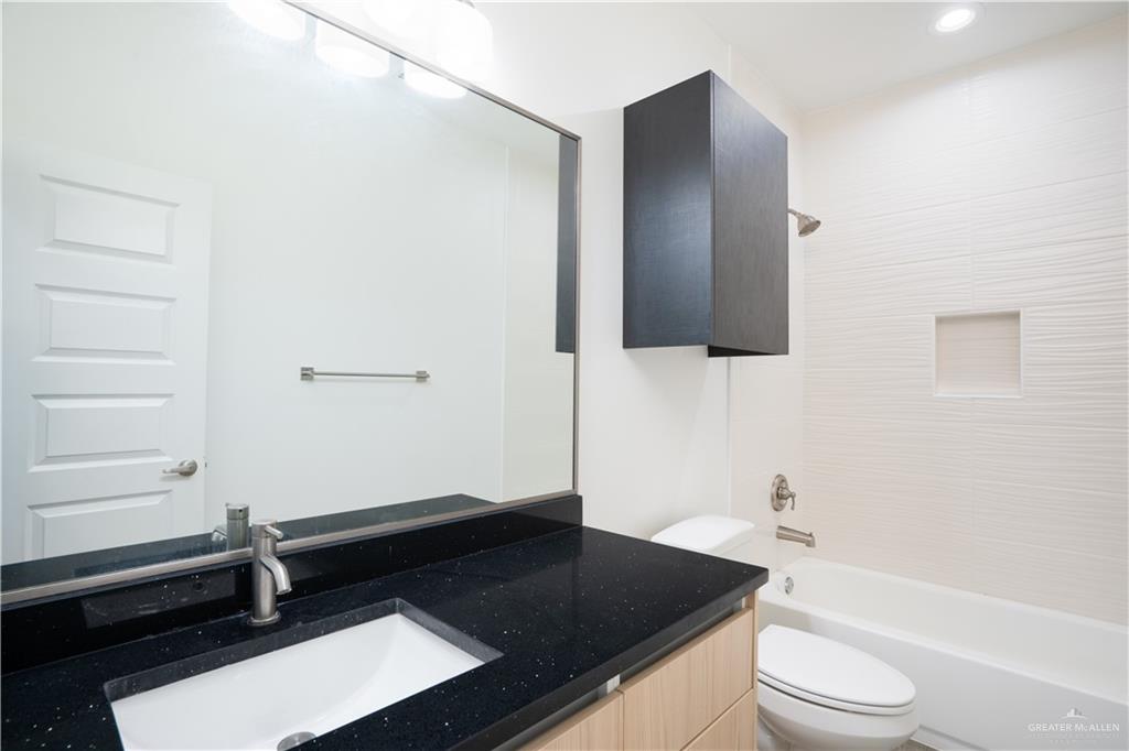 12509 North 40th Street, Unit 4 Edinburg, TX 78541 - Photo 9 of 27 a bathroom with a sink a toilet and shower