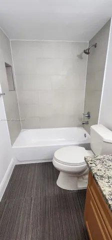 a bathroom with a toilet and a bathtub