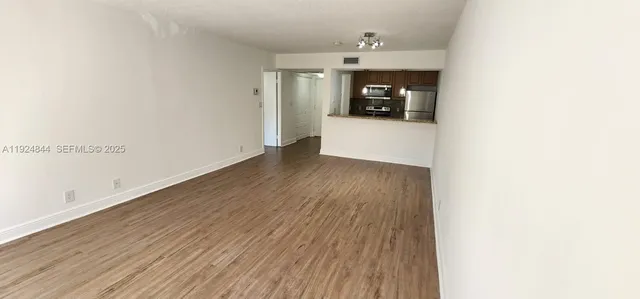a view of a utility room with wooden floor and a sink