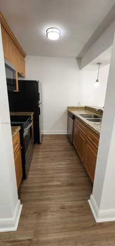 a view of a kitchen from the hallway