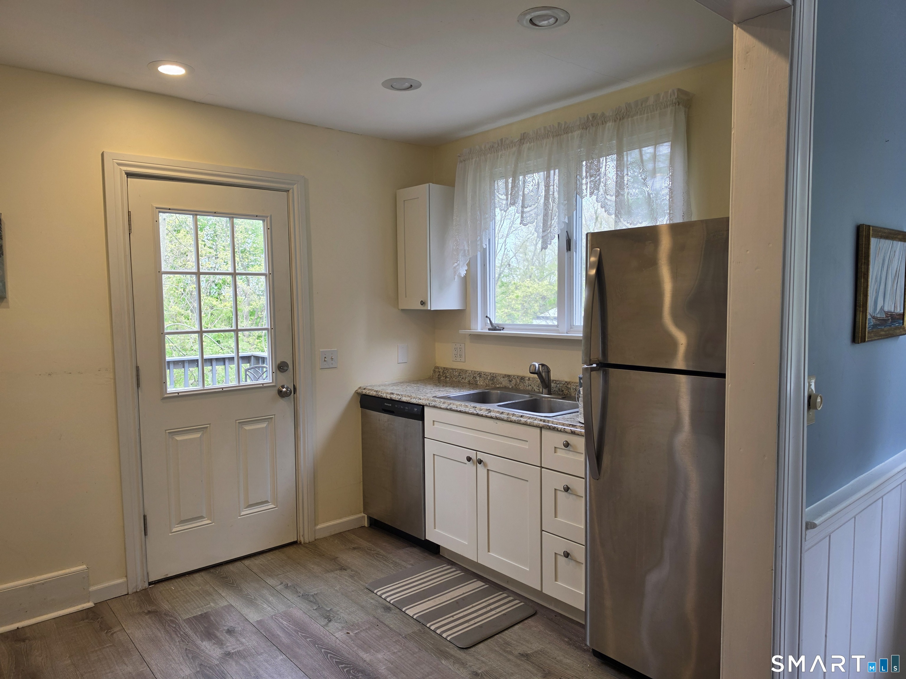 22 High Ridge Road Guilford, CT 06437 - Photo 9 of 16 a kitchen with a refrigerator sink and cabinets