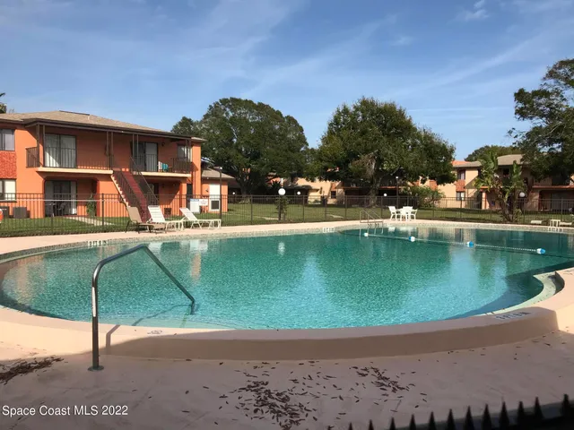 a view of a livingroom with furniture and staircase