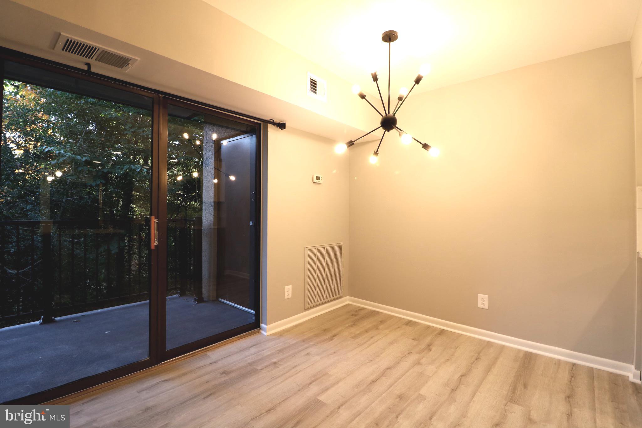 2249 Castle Rock Square, Unit 11C Reston, VA 20191 - Photo 11 of 26 a view of empty room with wooden floor and fan