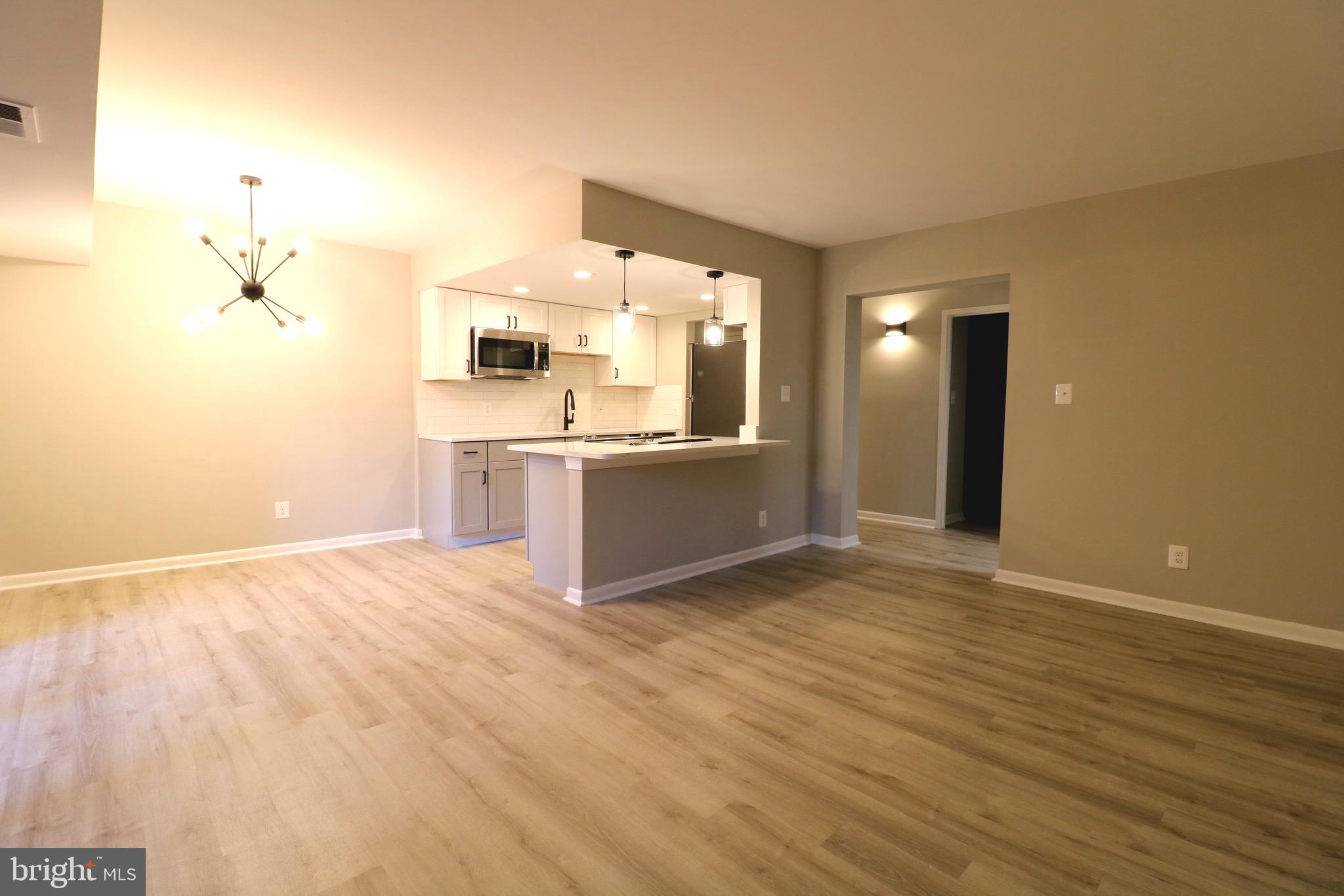 2249 Castle Rock Square, Unit 11C Reston, VA 20191 - Photo 12 of 26 a view of a kitchen with a sink and a stove top oven