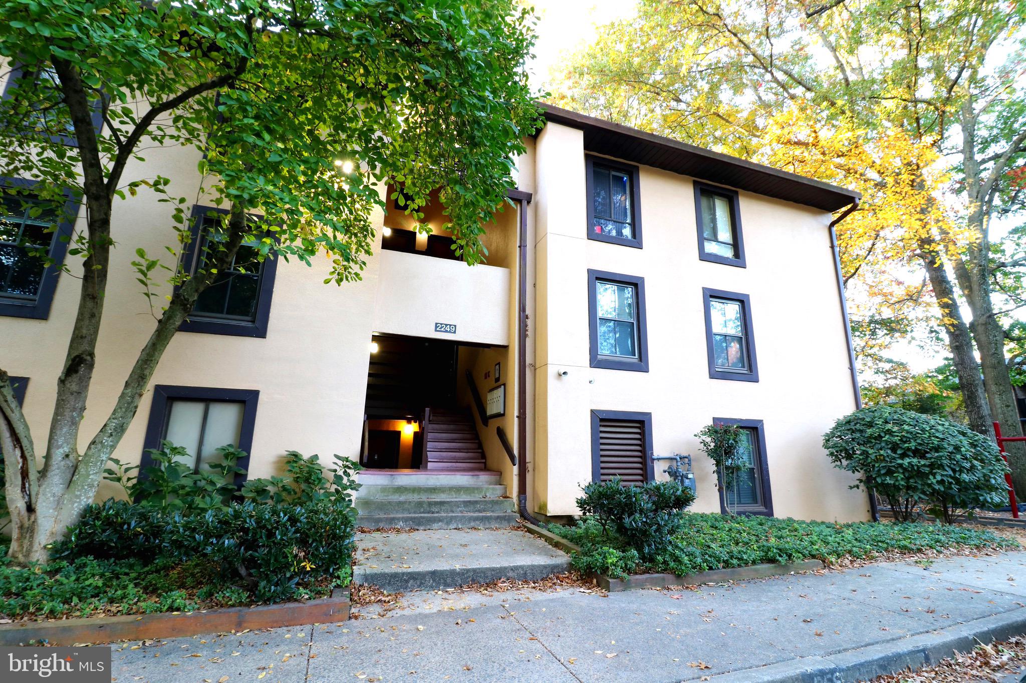 2249 Castle Rock Square, Unit 11C Reston, VA 20191 - Photo 2 of 26 a front view of a house with a yard