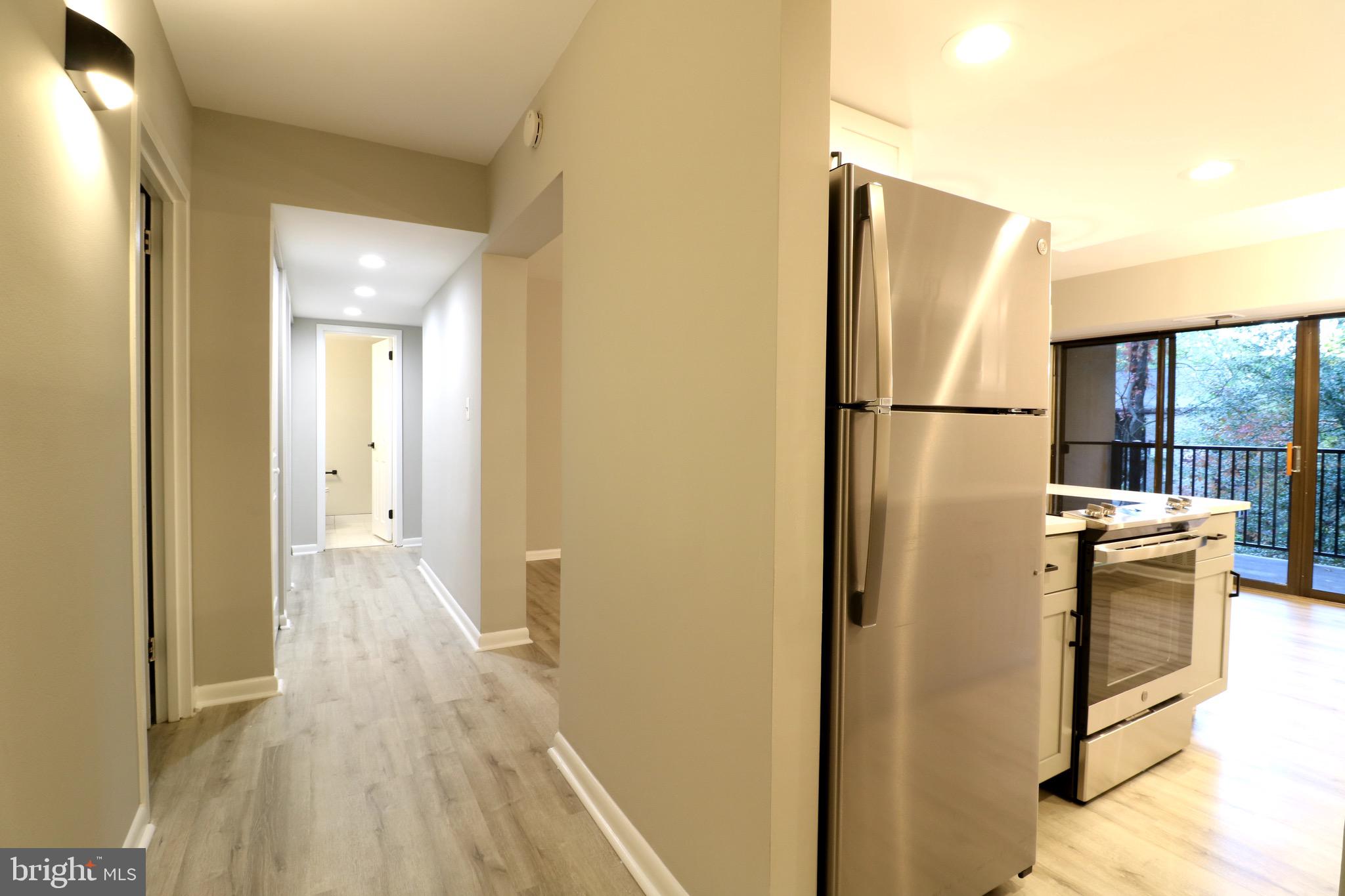2249 Castle Rock Square, Unit 11C Reston, VA 20191 - Photo 3 of 26 a view of a refrigerator in kitchen and wooden floor