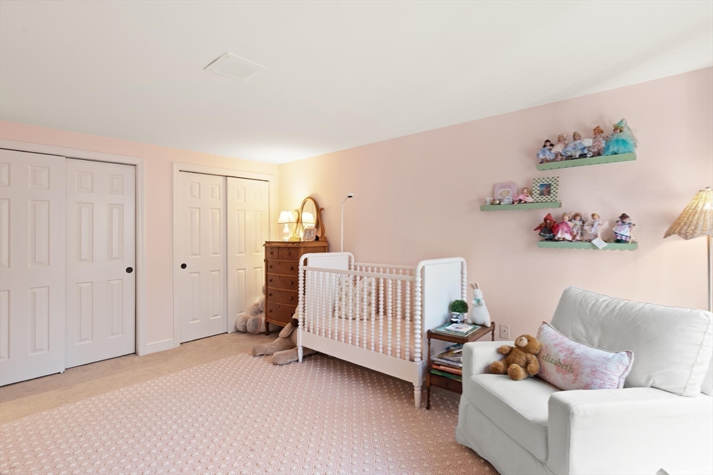 300 Willow Street, Unit 3 Hamilton, MA 01982 - Photo 23 of 39 a living room with furniture and a baby crib