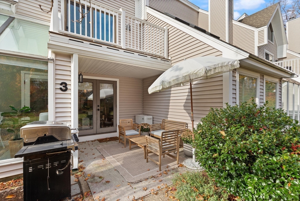 300 Willow Street, Unit 3 Hamilton, MA 01982 - Photo 32 of 39 a view of a patio with table and chairs and potted plants