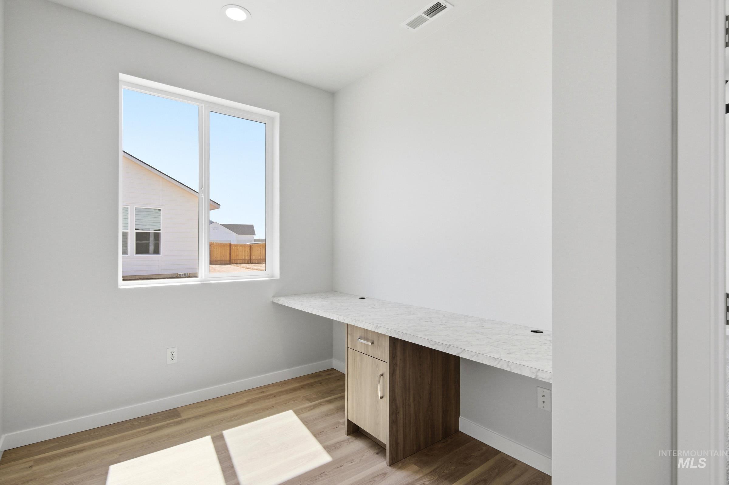 13649 Inman Court Caldwell, ID 83607 - Photo 14 of 22 Built-in desk featuring a light-toned wood-finish cabinet and a light-toned countertop