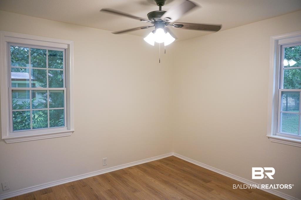 4734 Kirkwell Drive Mobile, AL 36619 - Photo 15 of 18 Unfurnished room with ceiling fan and hardwood / wood-style flooring