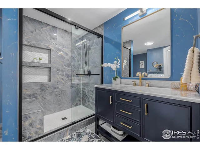 a bathroom with a shower sink and mirror