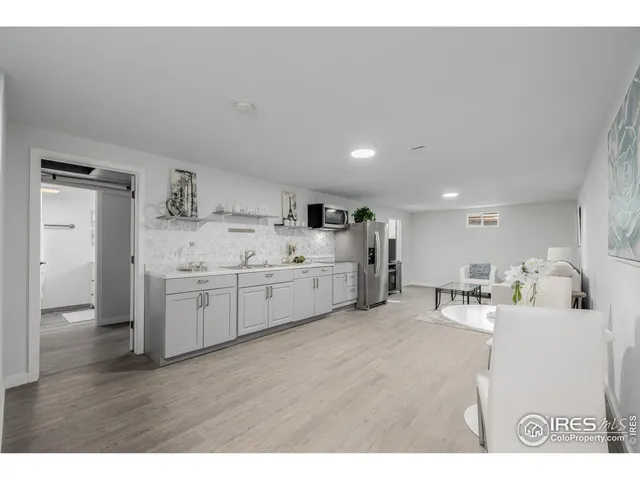 a kitchen with a sink cabinets and wooden floor