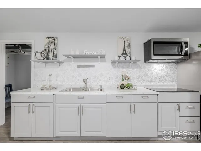 a kitchen with stainless steel appliances granite countertop a sink and a microwave