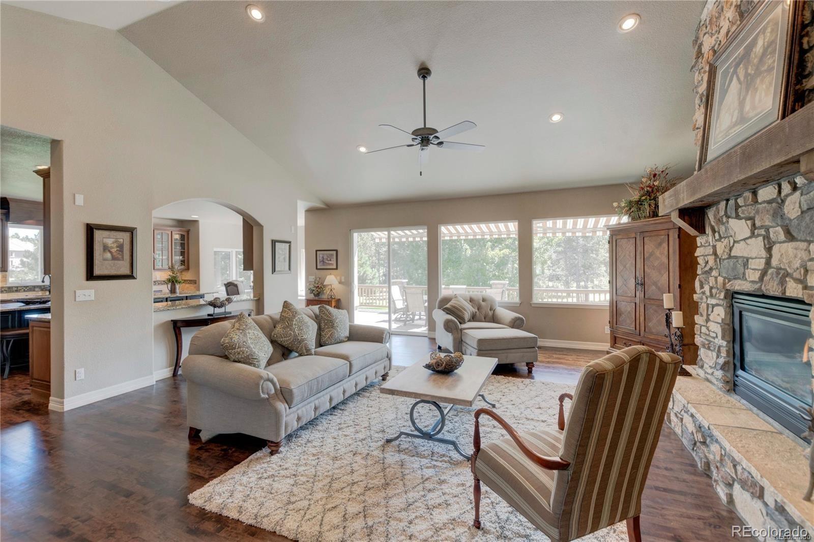 5283 Pinyon Jay Road Parker, CO 80134 - Photo 2 of 12 a living room with furniture fireplace and a flat screen tv