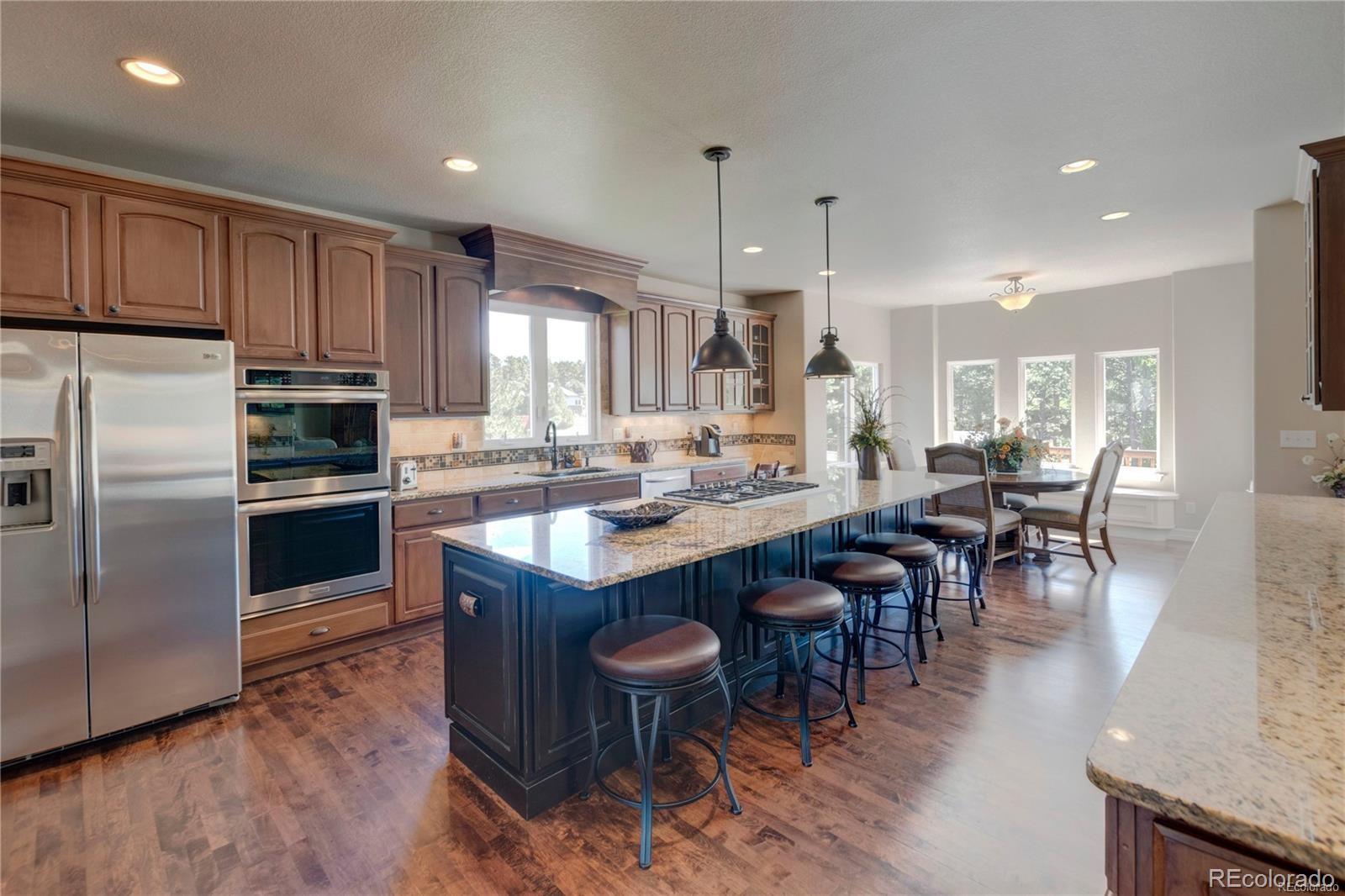 5283 Pinyon Jay Road Parker, CO 80134 - Photo 3 of 12 a kitchen with lots of counter top space and appliances
