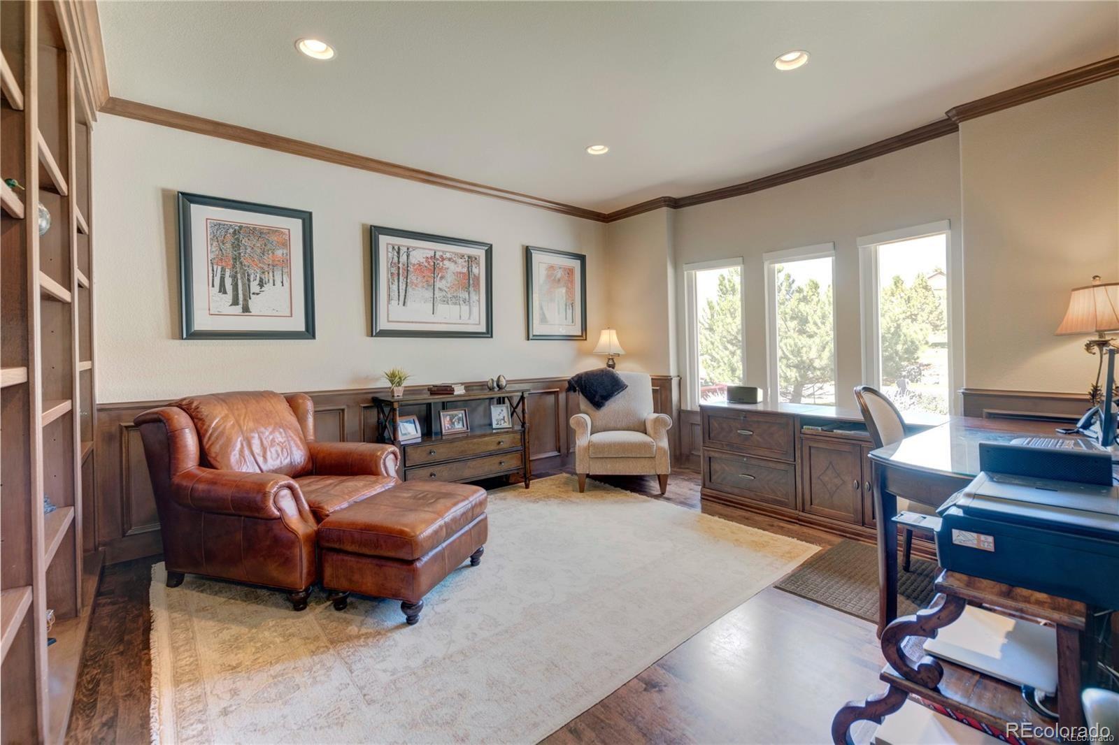 5283 Pinyon Jay Road Parker, CO 80134 - Photo 7 of 12 a living room with furniture flat screen tv and a large window