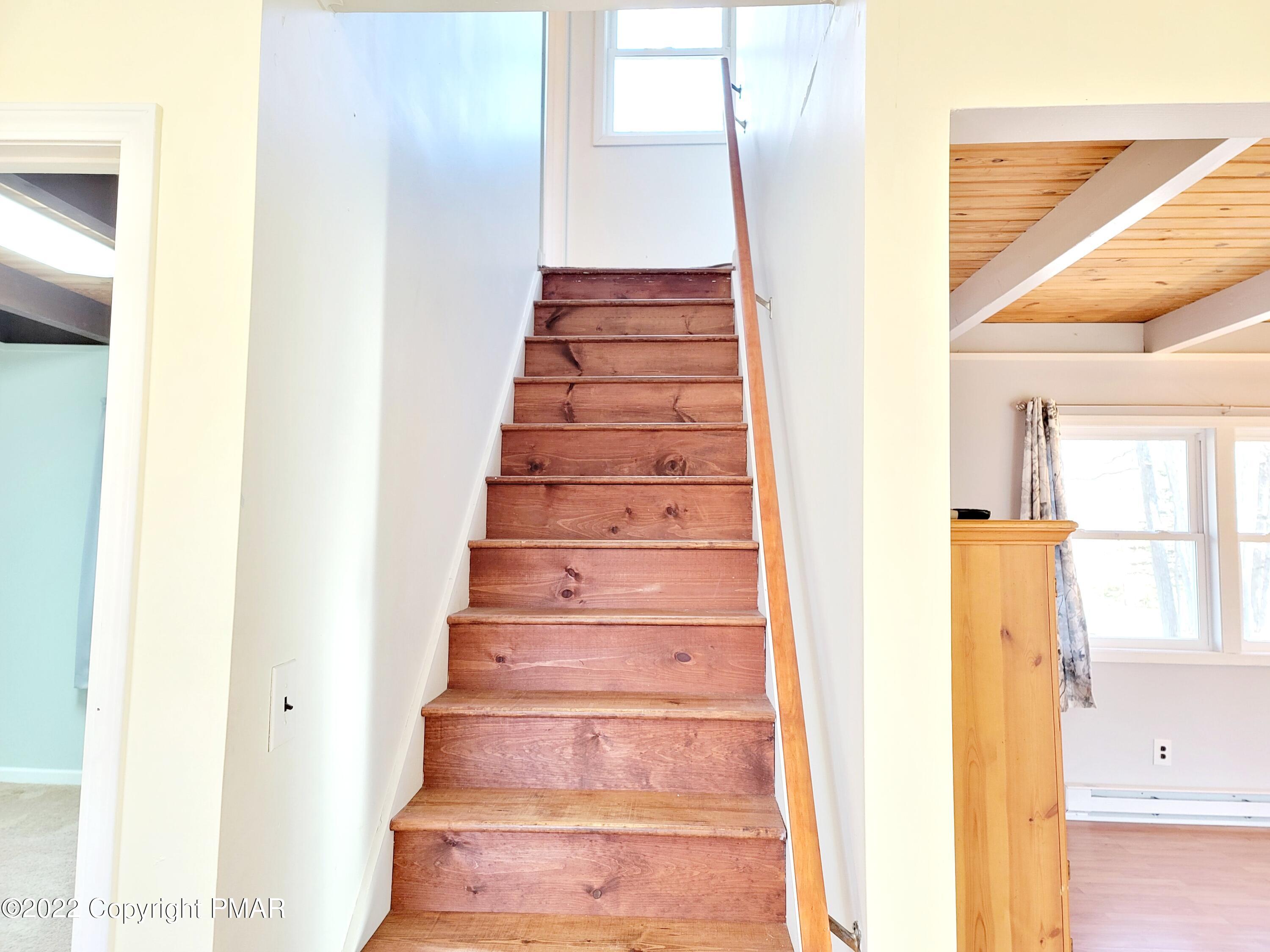 132 Rodeo Drive Hawley, PA 18428 - Photo 12 of 26 a view of staircase with white walls and a window