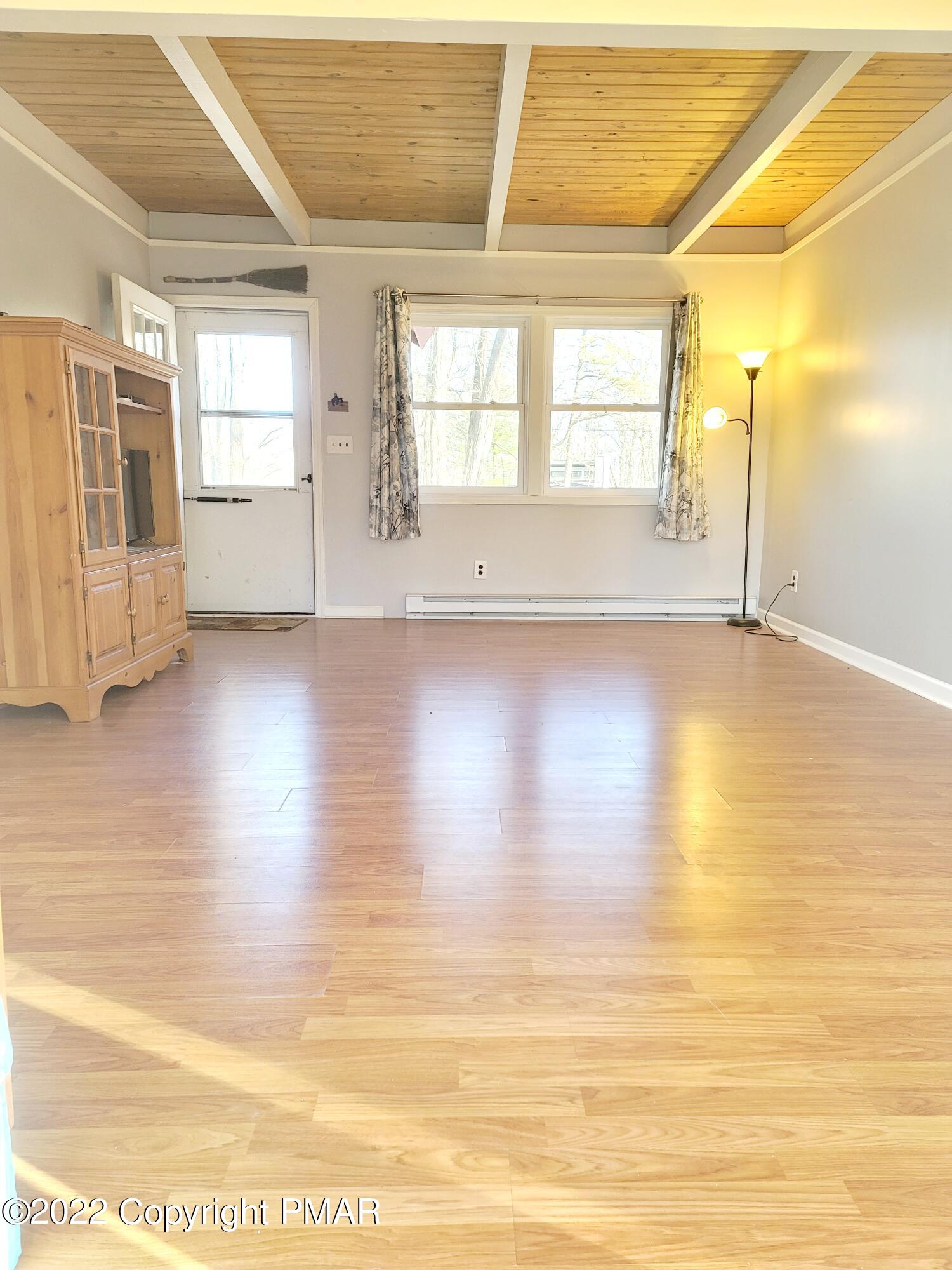 132 Rodeo Drive Hawley, PA 18428 - Photo 4 of 26 a view of empty room with wooden floor and fan